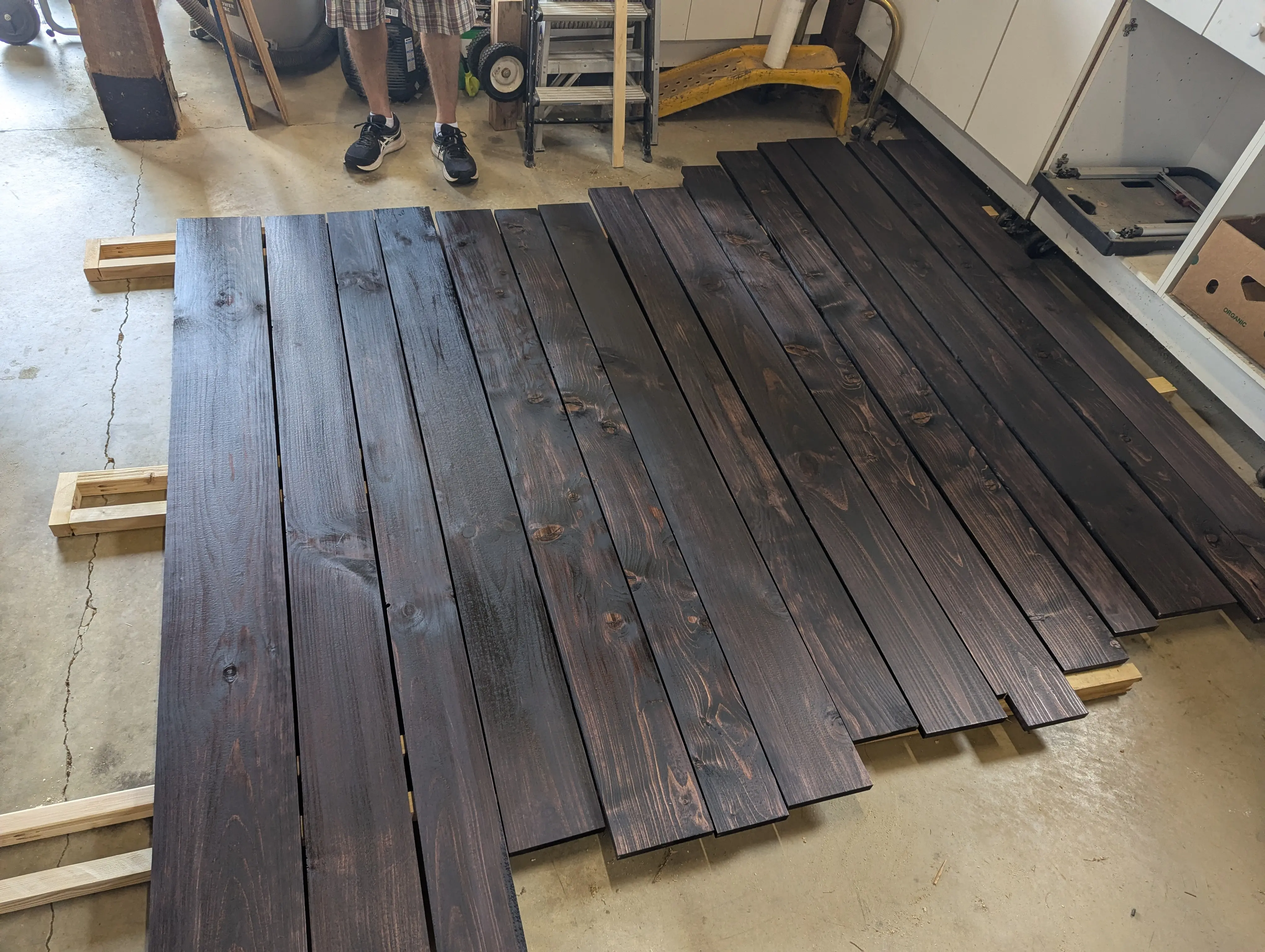 Wide plank pine flooring cut to size and stained for the Swig Rig