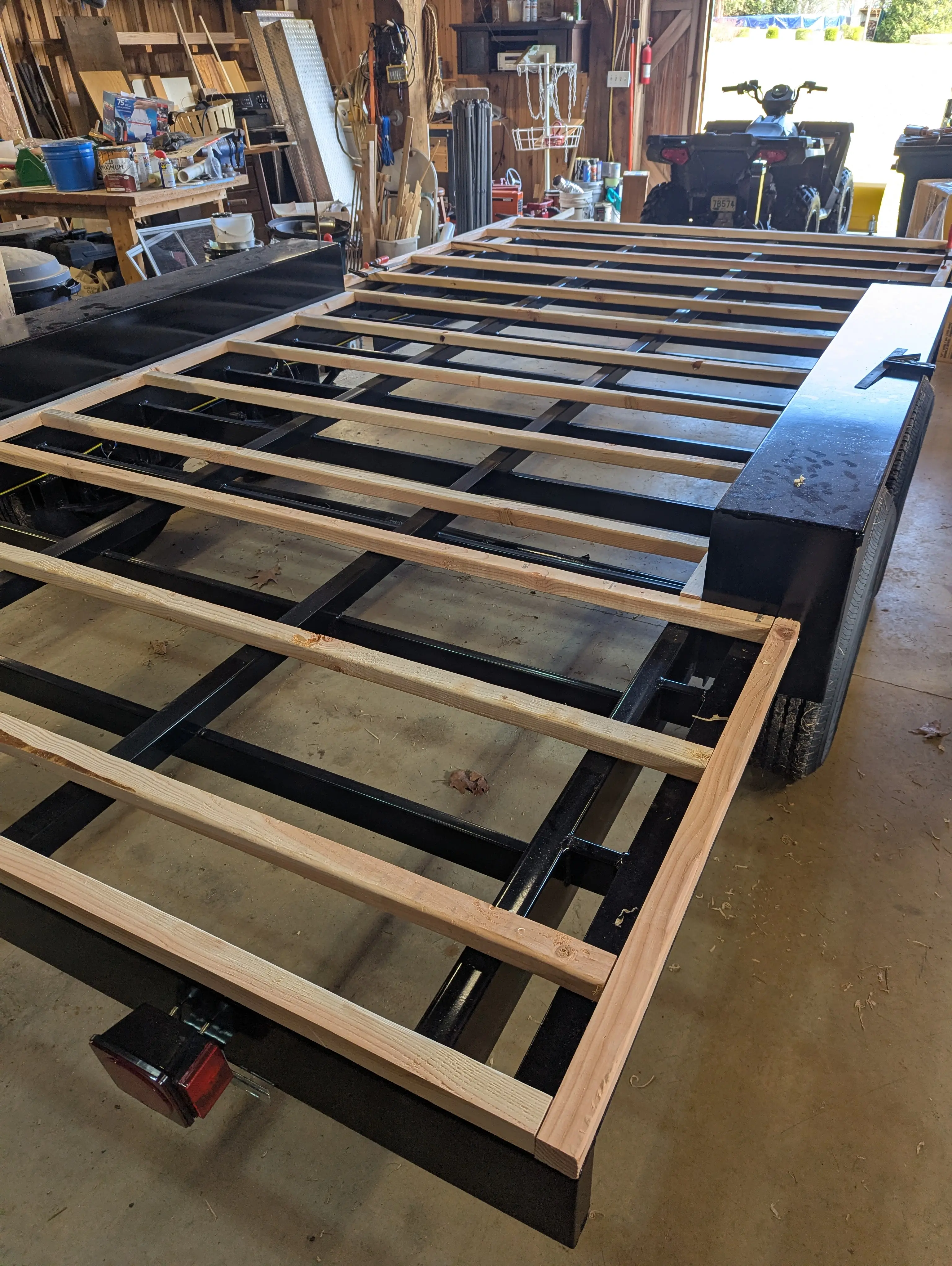 Trailer frame with wood floor joists being laid — the very beginning