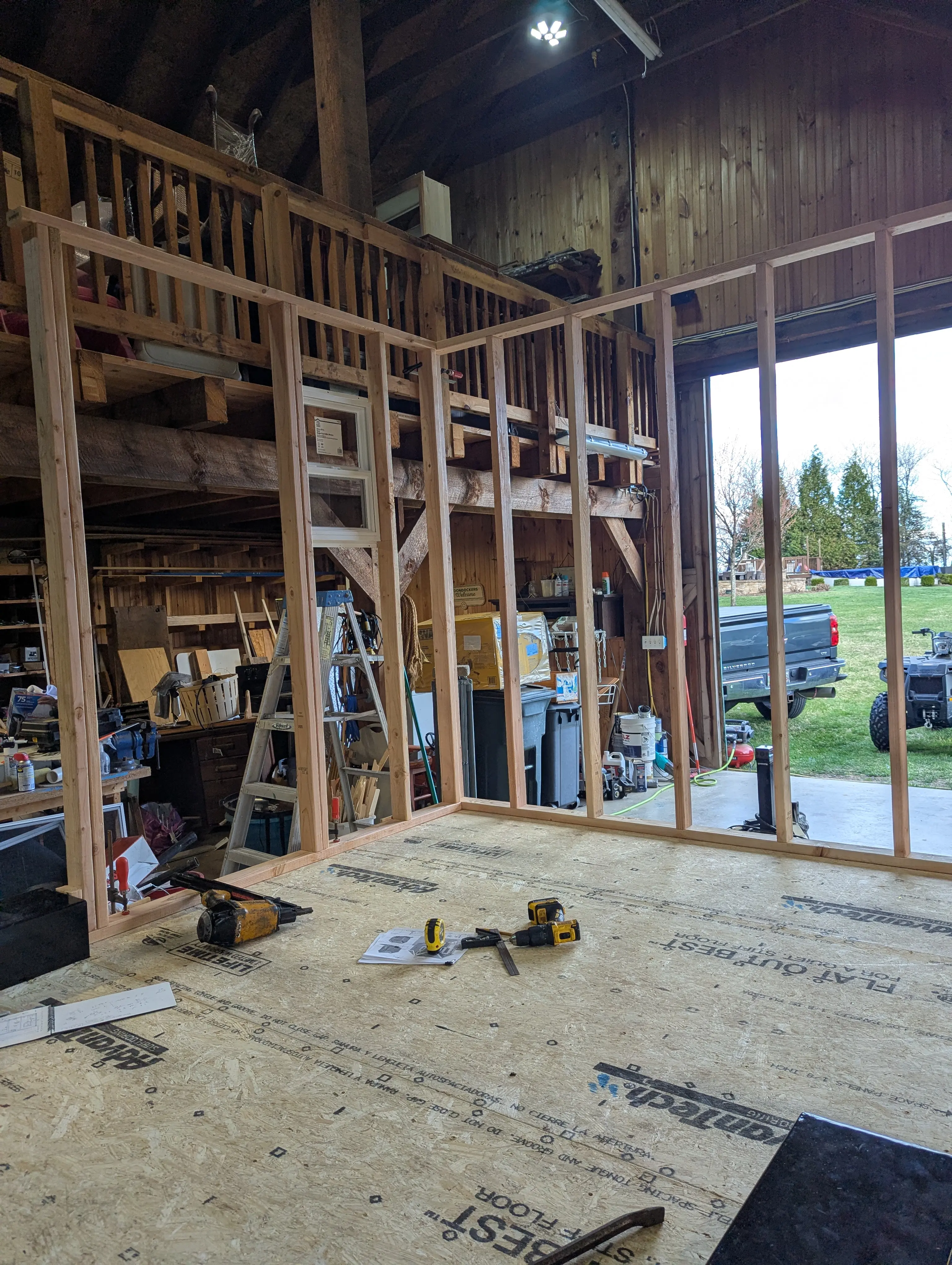 First wall frames standing up in the barn