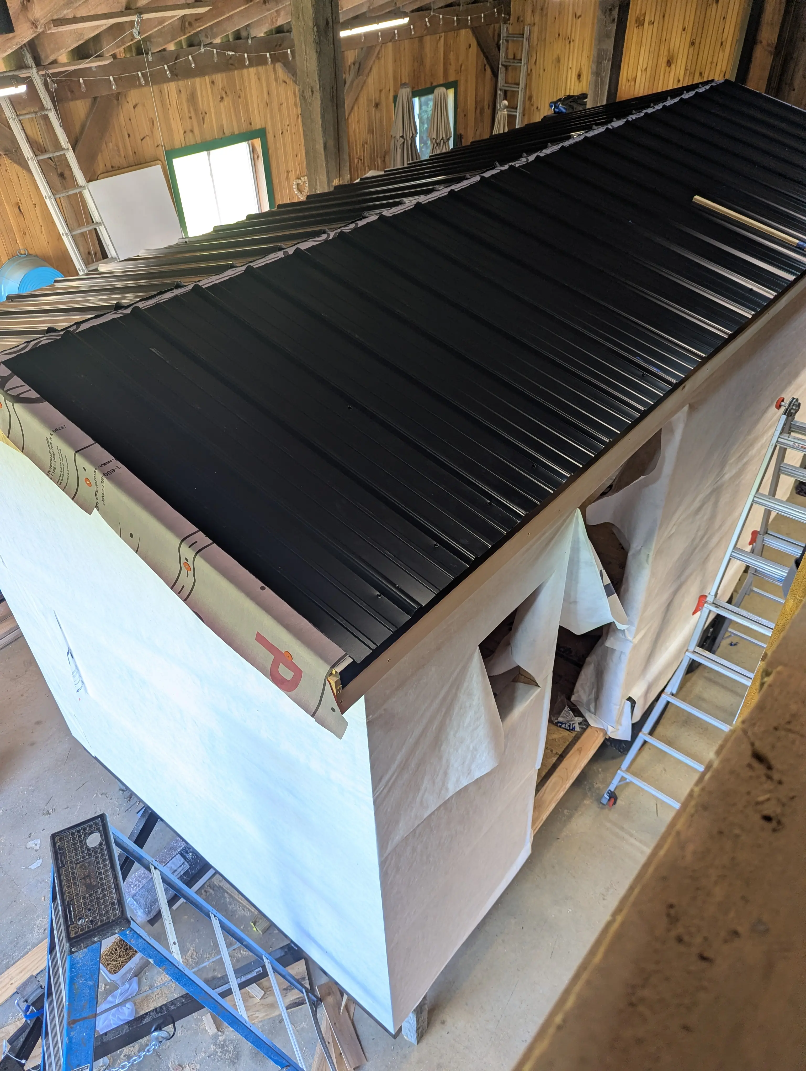 Black standing seam metal roof installed on the Swig Rig